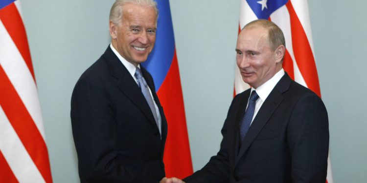 FILE - In this March 10, 2011, file photo, Vice President of the United States Joe Biden, left, shakes hands with Russian Prime Minister Vladimir Putin in Moscow, Russia. Putin won’t congratulate President-elect Joe Biden until legal challenges to the U.S. election are resolved and the result is official, the Kremlin announced Monday, Nov. 9, 2020. (AP Photo/Alexander Zemlianichenko, File)