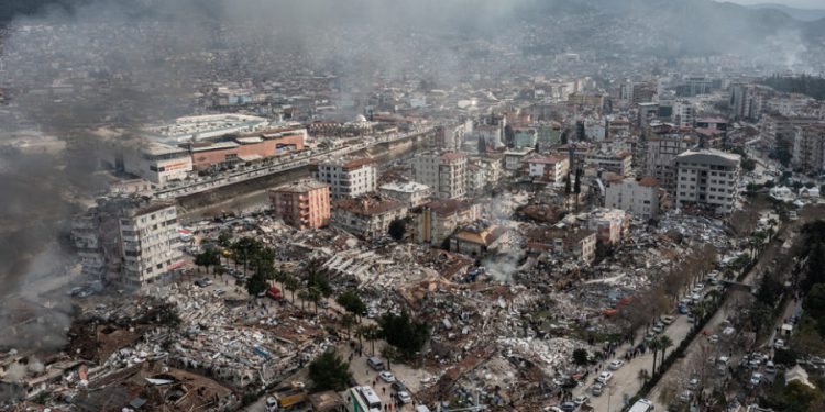 HATAY, TURKEY - FEBRUARY 07: Smoke billows from the scene of a collapsed buildings on February 07, 2023 in Hatay, Turkey. A 7.8-magnitude earthquake hit near Gaziantep, Turkey, in the early hours of Monday, followed by another 7.5-magnitude tremor just after midday. The quakes caused widespread destruction in southern Turkey and northern Syria and were felt in nearby countries.  (Photo by Burak Kara/Getty Images)
